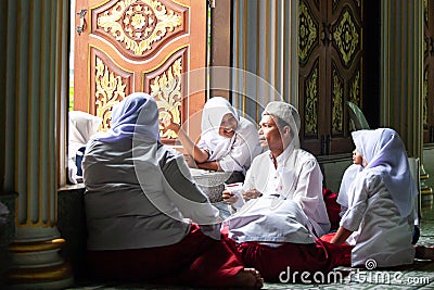 Happy lovely muslim young girls in traditional clothing with male muslim teacher inside the mosque. Nong Chok, Bangkok, Thailand Editorial Stock Photo